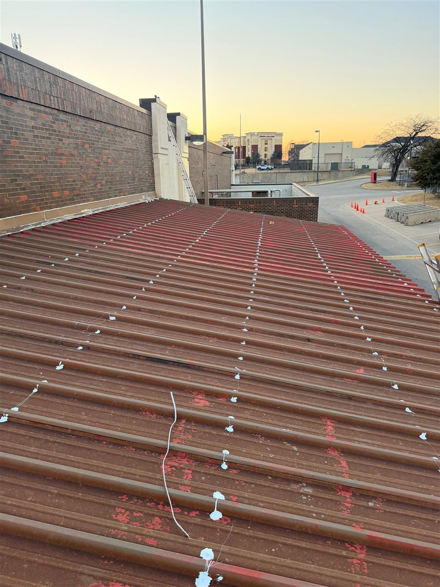 Red metal roof with sealed screw heads and seams
